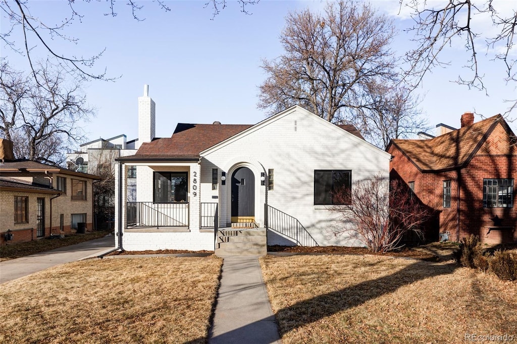 bungalow-style home with a porch and a front yard