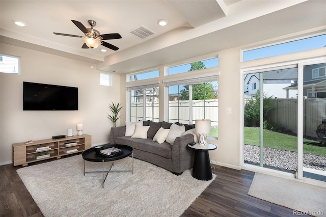 living room with dark hardwood / wood-style flooring and ceiling fan