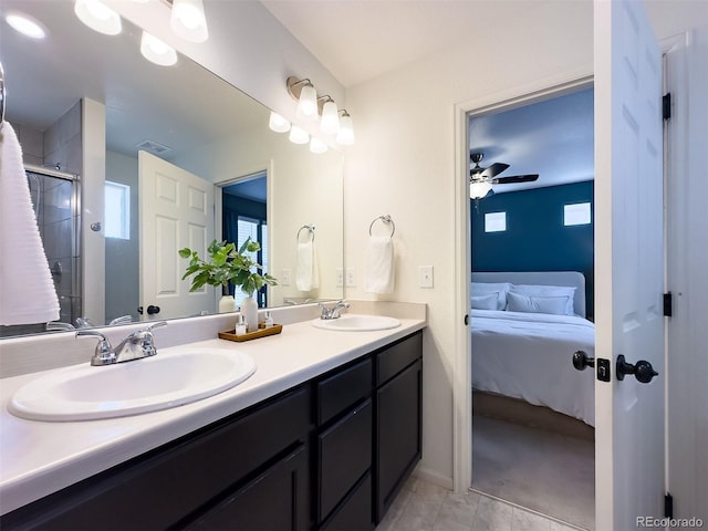 bathroom featuring a shower with door, oversized vanity, tile flooring, dual sinks, and ceiling fan