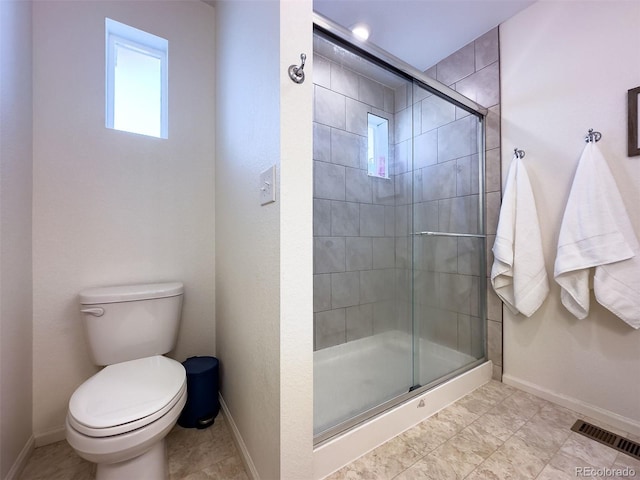 bathroom featuring tile flooring, an enclosed shower, and toilet