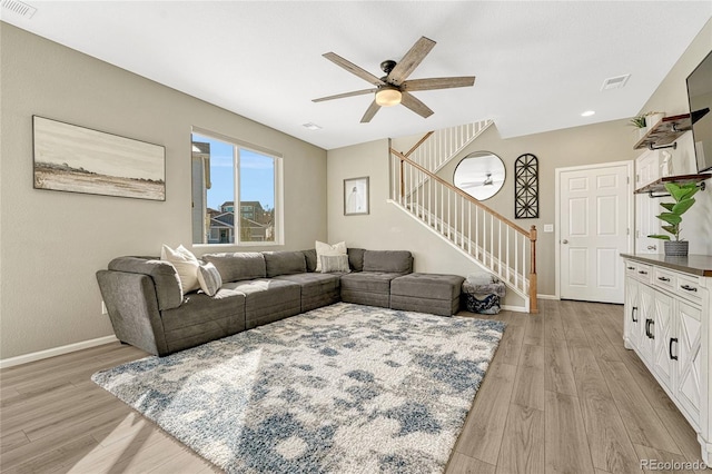 living room featuring ceiling fan and light hardwood / wood-style flooring