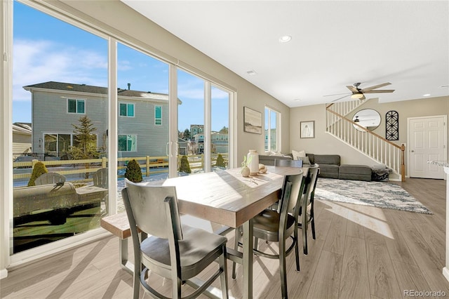 dining space featuring ceiling fan and light hardwood / wood-style flooring