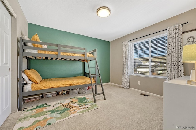 bedroom featuring light colored carpet and a closet