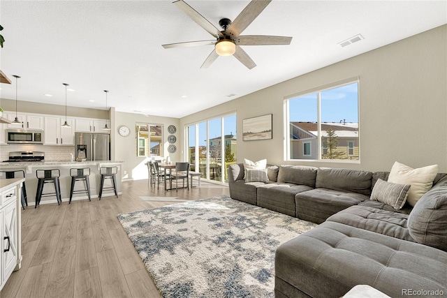 1886 Makley Loop, Castle Rock, CO 80104 - living area featuring a ceiling fan, light wood finished floors, and recessed lighting