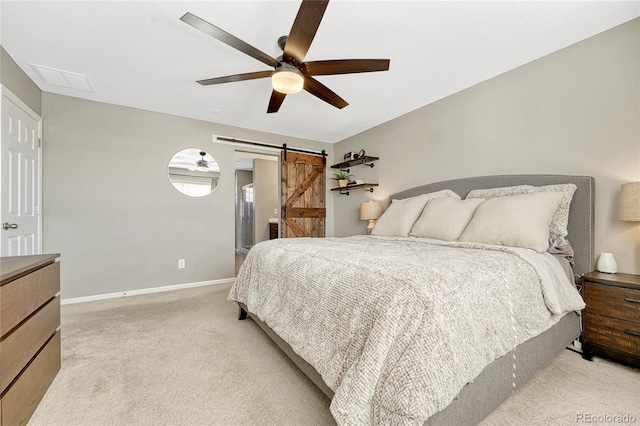 1886 Makley Loop, Castle Rock, CO 80104 - bedroom with light carpet, a barn door, baseboards, and ceiling fan