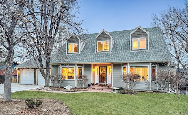 cape cod-style house featuring a shingled roof, fence, a front yard, driveway, and an attached garage