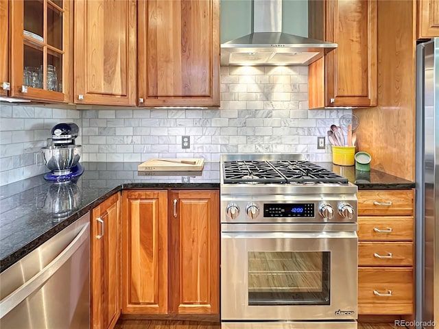 kitchen with backsplash, wall chimney exhaust hood, and appliances with stainless steel finishes