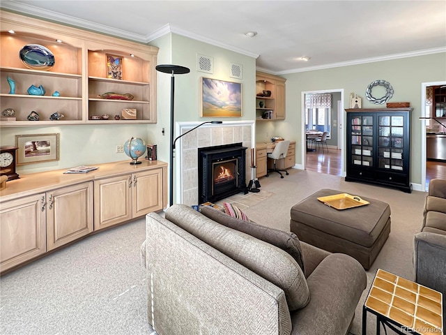 living area featuring visible vents, light colored carpet, a tile fireplace, and crown molding