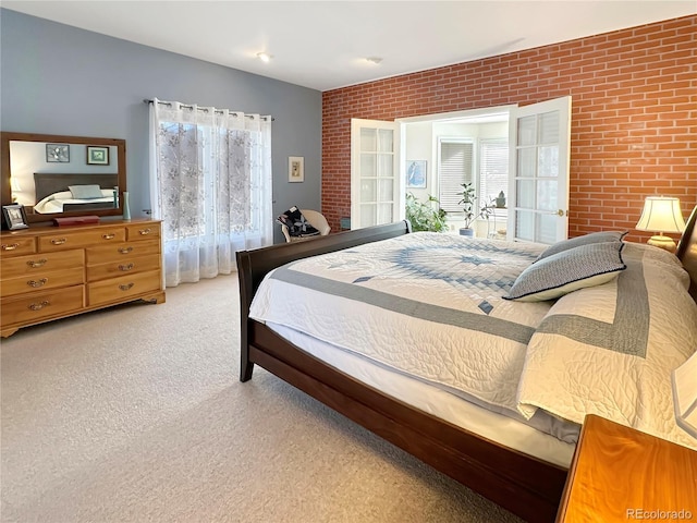 carpeted bedroom with brick wall