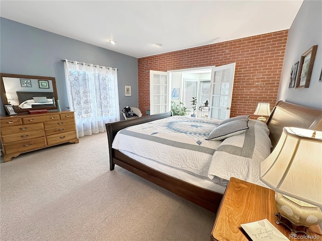 bedroom featuring carpet flooring and brick wall