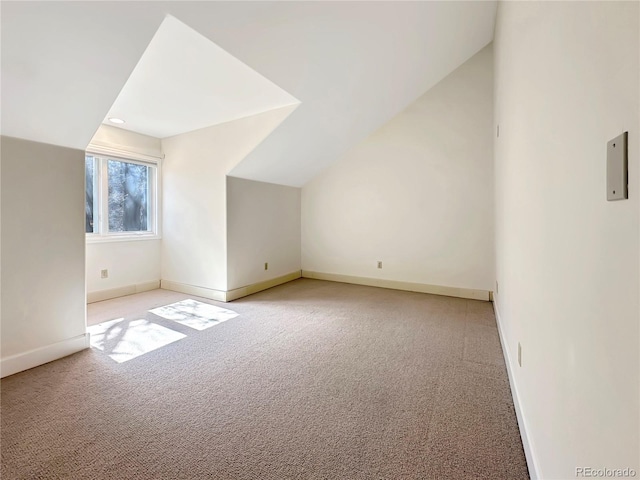 bonus room with light colored carpet, baseboards, and lofted ceiling