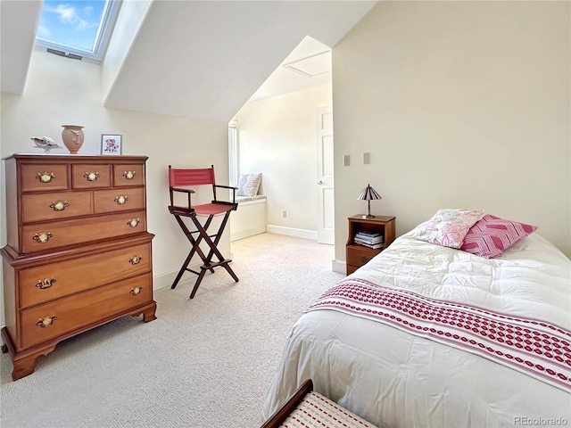 bedroom with lofted ceiling with skylight, light colored carpet, and baseboards