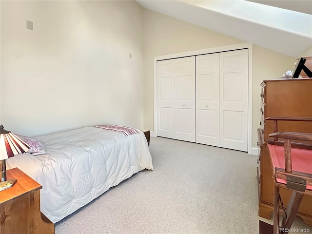 bedroom featuring a closet, carpet, and lofted ceiling