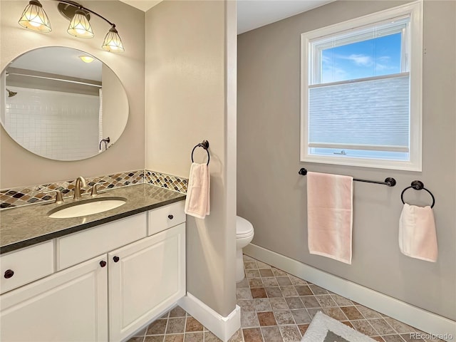 full bathroom featuring toilet, vanity, and baseboards