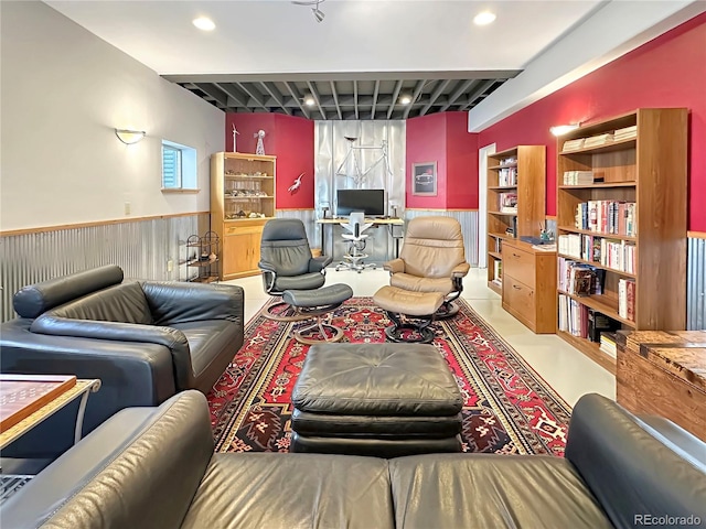 living area with recessed lighting and wainscoting