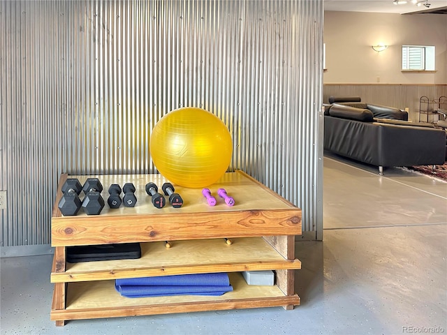 interior space with concrete floors and wainscoting