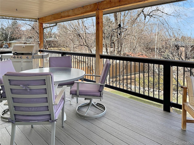 wooden deck featuring outdoor dining area and grilling area