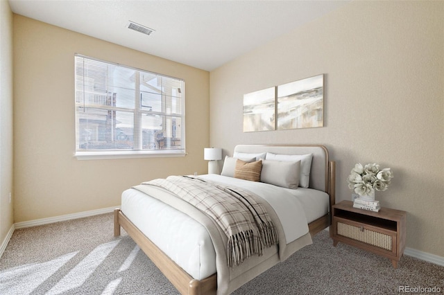 bedroom featuring carpet floors, visible vents, and baseboards