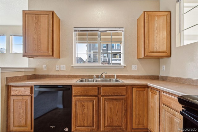 kitchen with dishwasher, light countertops, and a sink