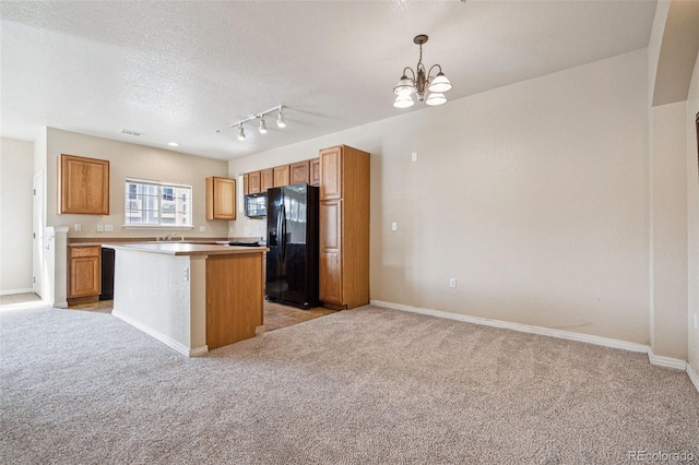 kitchen featuring light colored carpet, a kitchen island, brown cabinets, decorative light fixtures, and black appliances