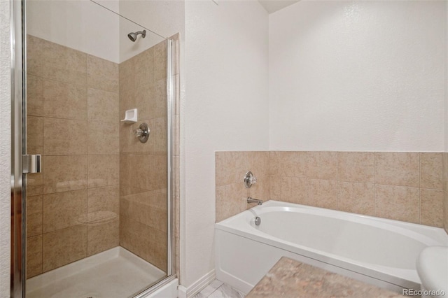 full bathroom with a stall shower, a garden tub, and baseboards