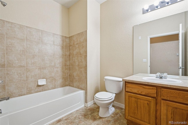 bathroom featuring tile patterned flooring, shower / tub combination, toilet, vanity, and baseboards