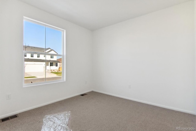 carpeted spare room with plenty of natural light