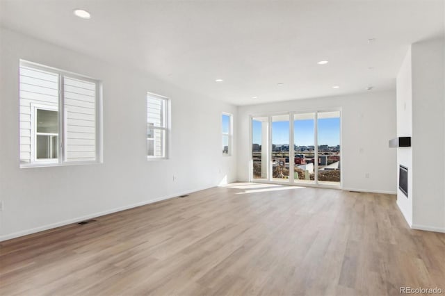 unfurnished living room with light hardwood / wood-style flooring