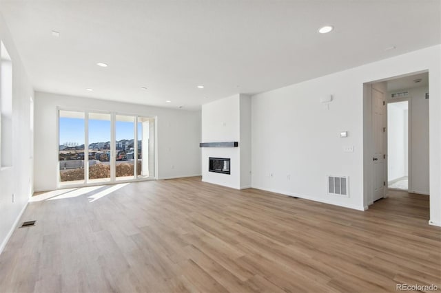 unfurnished living room with light hardwood / wood-style flooring