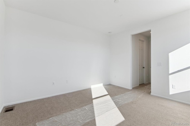 spare room with light colored carpet