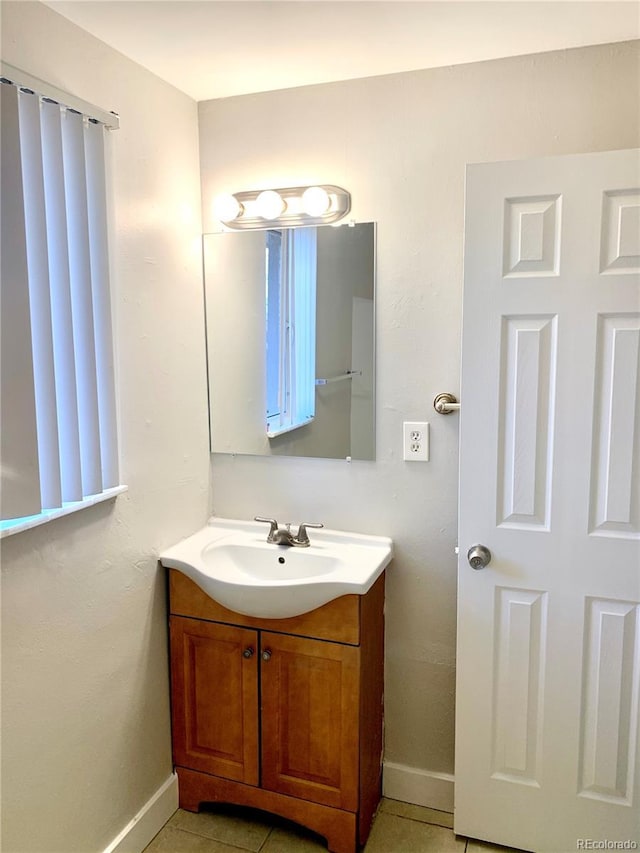 1143 Akron St, Aurora, CO 80010 - bathroom with baseboards and vanity