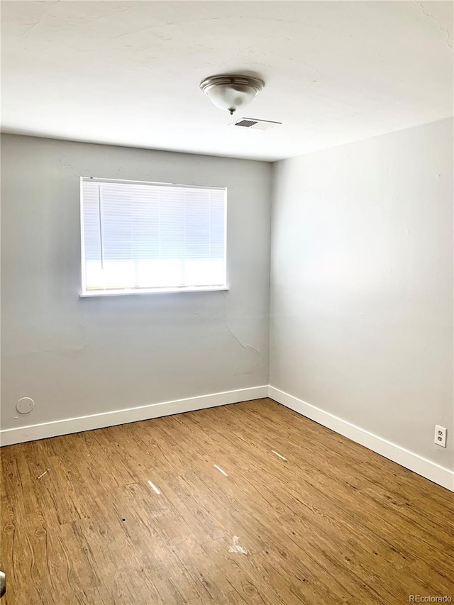 1143 Akron St, Aurora, CO 80010 - unfurnished room featuring baseboards and wood finished floors