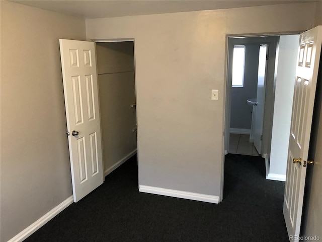 1143 Akron St, Aurora, CO 80010 - unfurnished bedroom with dark colored carpet and baseboards