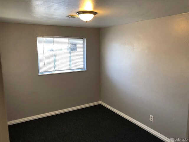 1143 Akron St, Aurora, CO 80010 - empty room with baseboards and dark carpet