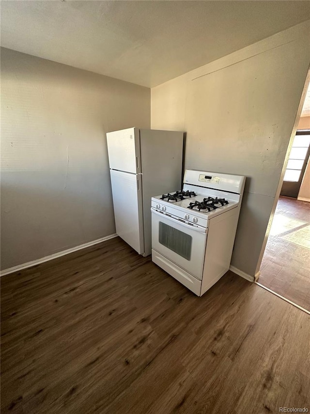1143 Akron St, Aurora, CO 80010 - kitchen featuring white appliances, dark wood-style flooring, and baseboards