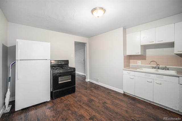 1143 Akron St, Aurora, CO 80010 - kitchen with freestanding refrigerator, black gas range, a sink, dark wood-style floors, and light countertops