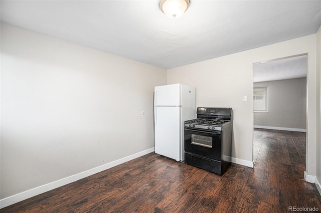 1143 Akron St, Aurora, CO 80010 - kitchen featuring black gas range, freestanding refrigerator, dark wood-style flooring, and baseboards