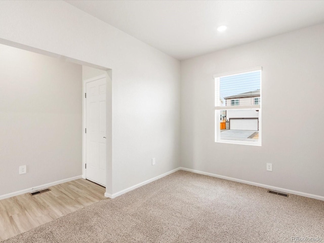 spare room with visible vents, carpet flooring, and baseboards