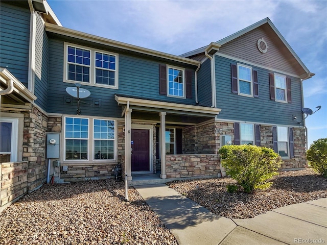 12713 Leyden St Unit E, Thornton, CO 80602 - view of front of home featuring stone siding and covered porch