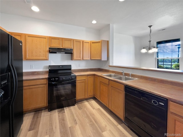 12713 Leyden St Unit E, Thornton, CO 80602 - kitchen featuring black appliances, a sink, under cabinet range hood, light wood finished floors, and a chandelier