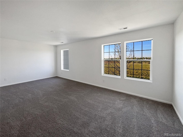 12713 Leyden St Unit E, Thornton, CO 80602 - unfurnished room featuring plenty of natural light, dark carpet, and baseboards