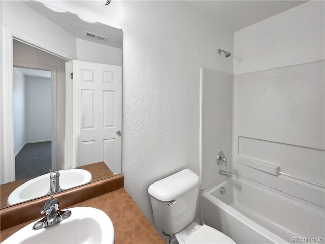 12713 Leyden St Unit E, Thornton, CO 80602 - bathroom featuring a sink, toilet, tub / shower combination, and a textured wall