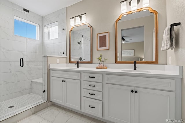 bathroom featuring ceiling fan, vanity, and an enclosed shower