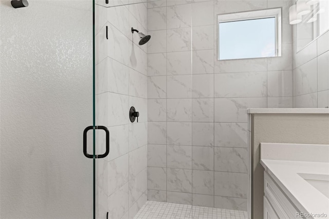 bathroom with vanity and a shower with shower door