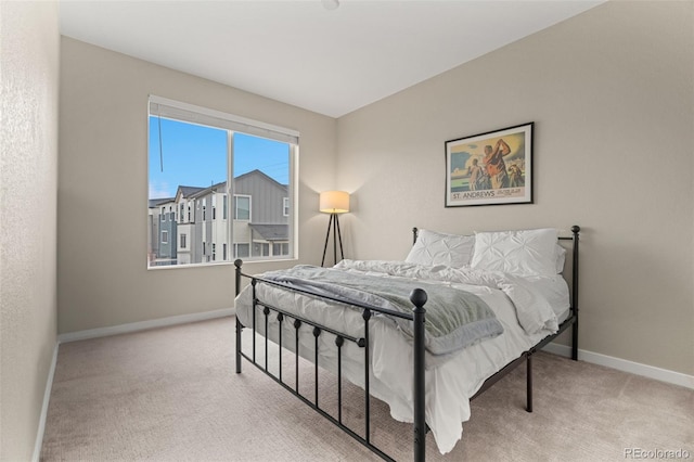 bedroom featuring light carpet