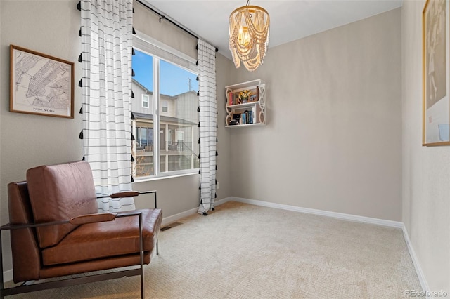 living area featuring light colored carpet and an inviting chandelier