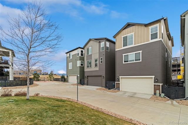 exterior space with a yard, a garage, and central air condition unit