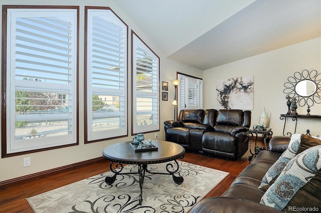 living room with dark hardwood / wood-style flooring and vaulted ceiling