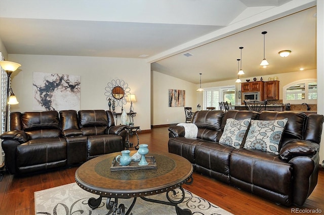 living room featuring lofted ceiling with beams, dark hardwood / wood-style flooring, and sink