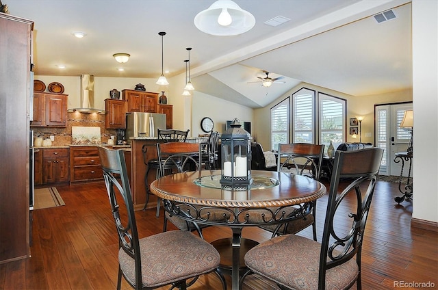 dining room with ceiling fan, vaulted ceiling with beams, and dark wood-type flooring